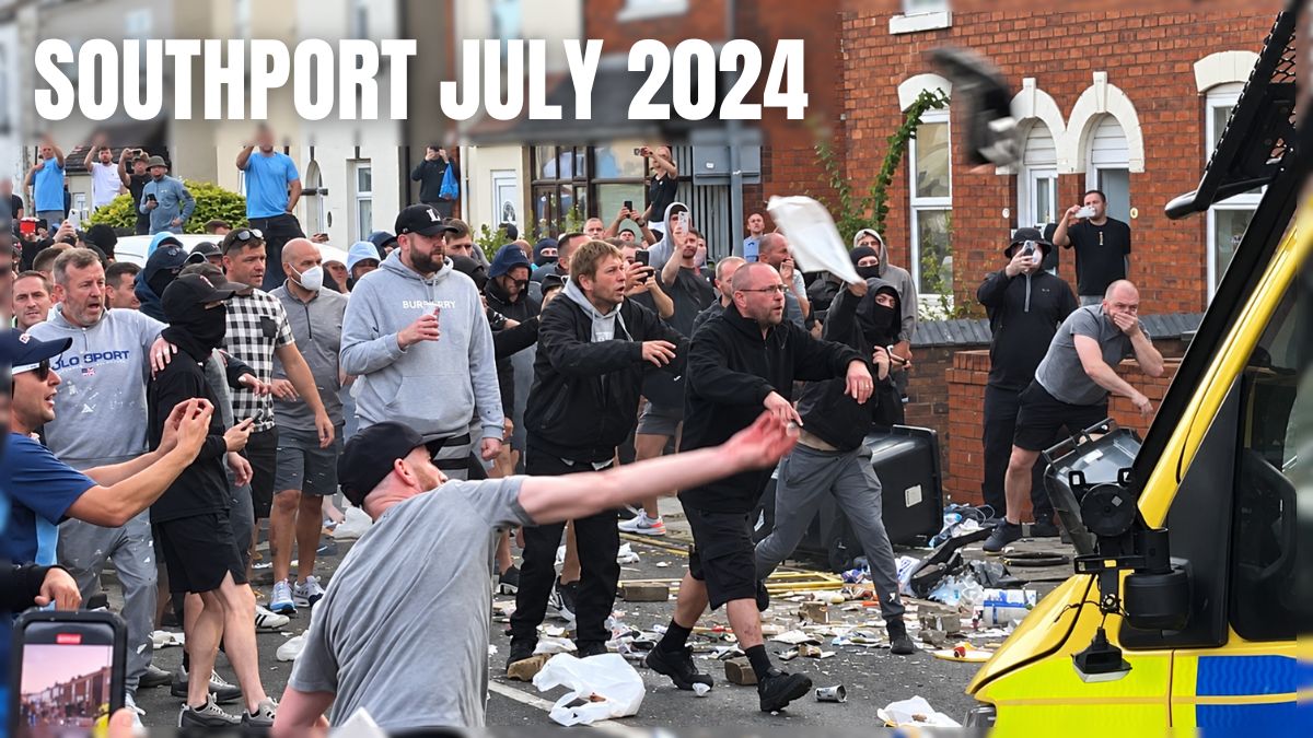 Police officers facing crowds during the August 2024 riots in England